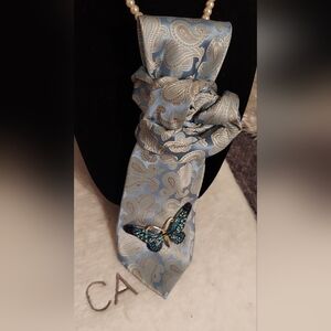 Elegant Blue and Silver Paisley Tie with Butterfly Accent